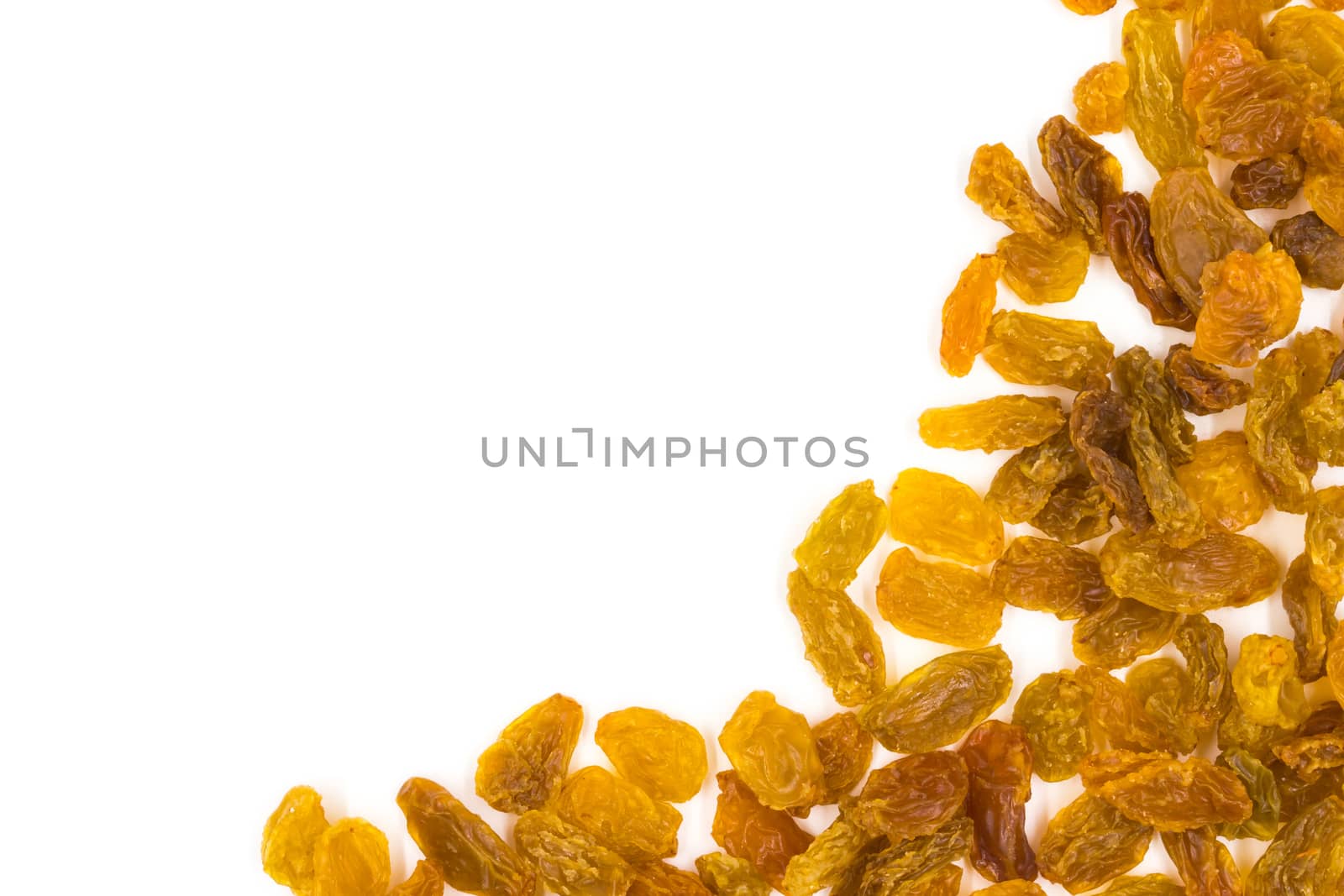 Yellow raisins on white background.