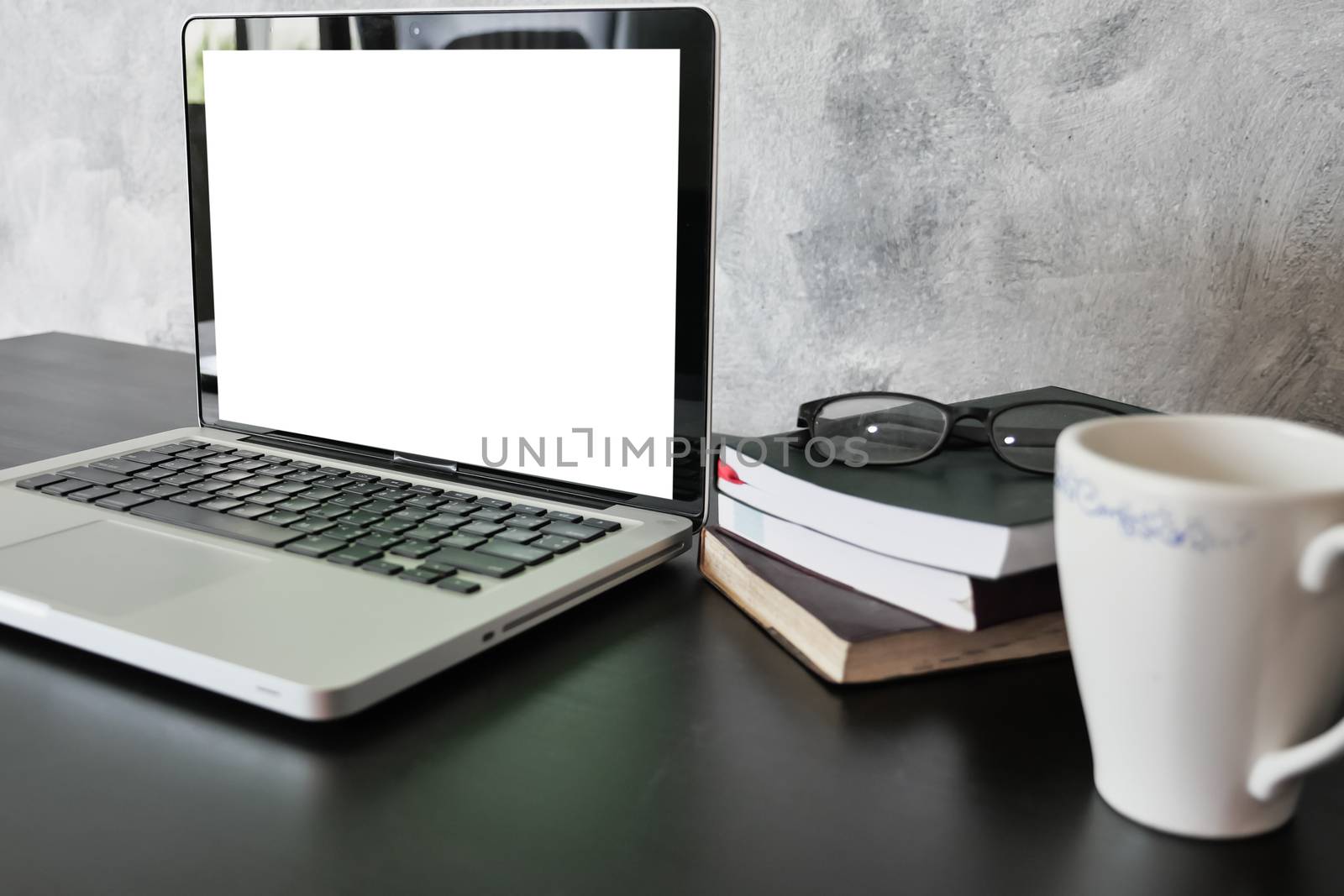 Laptop with white screen monitor on the desk.