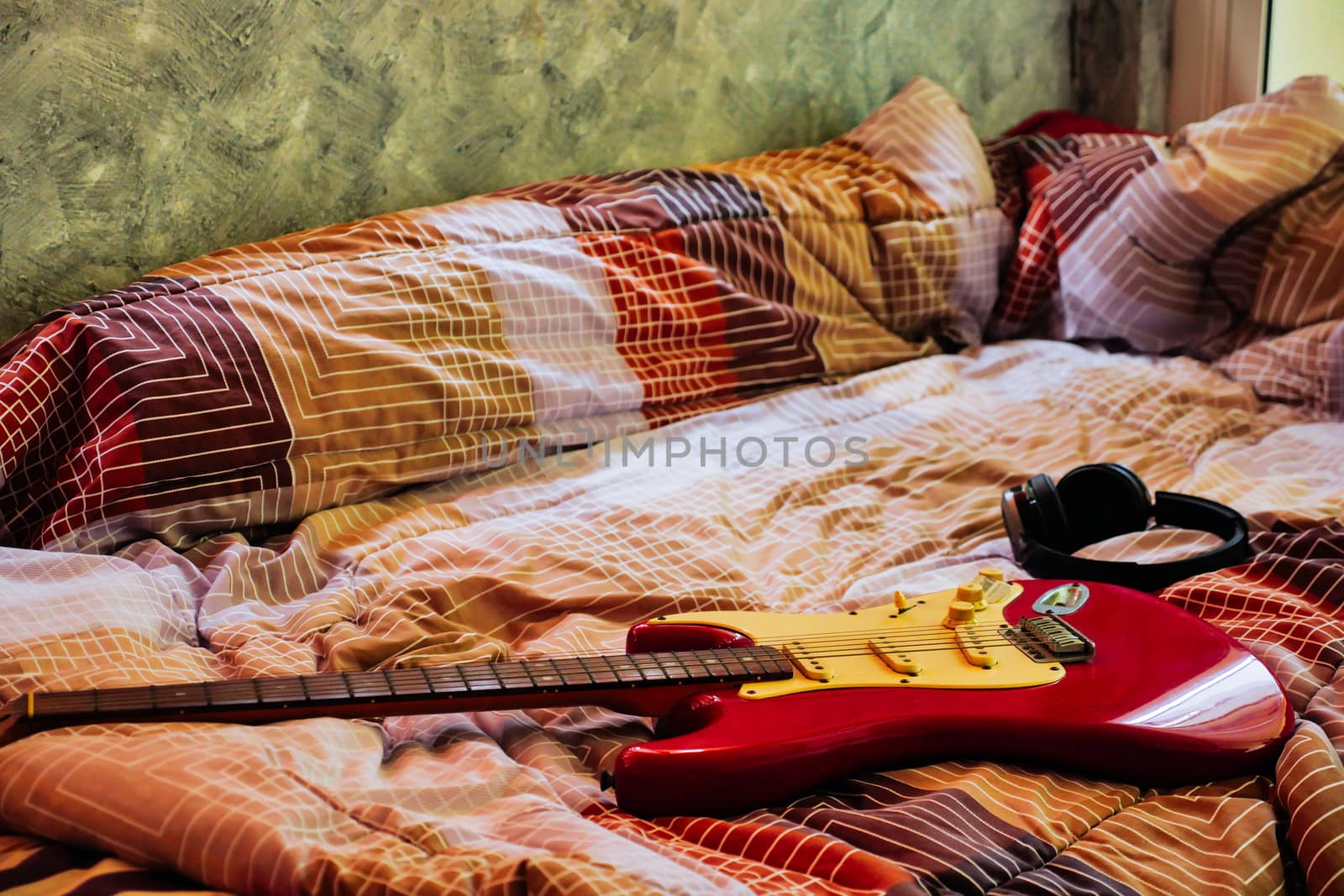 Electric guitar and headphones in bedroom, Films grain filter.