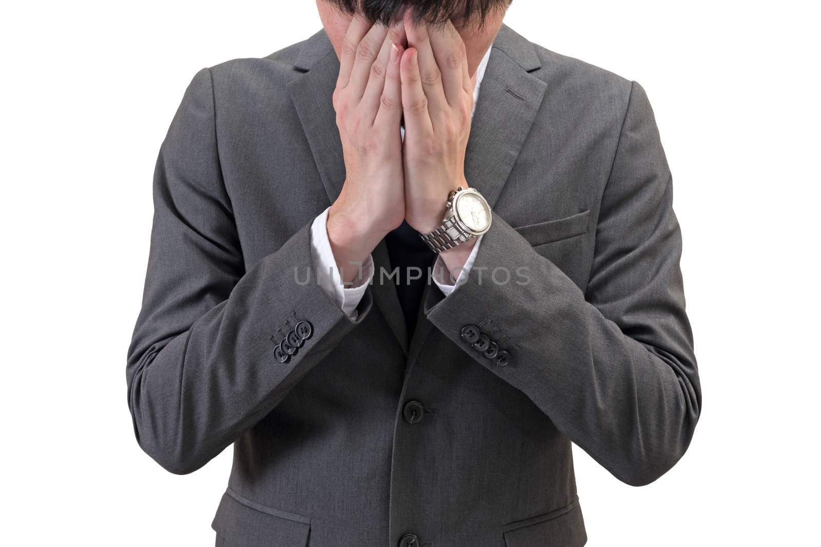Businessman covering his face with hands isolated on white background.