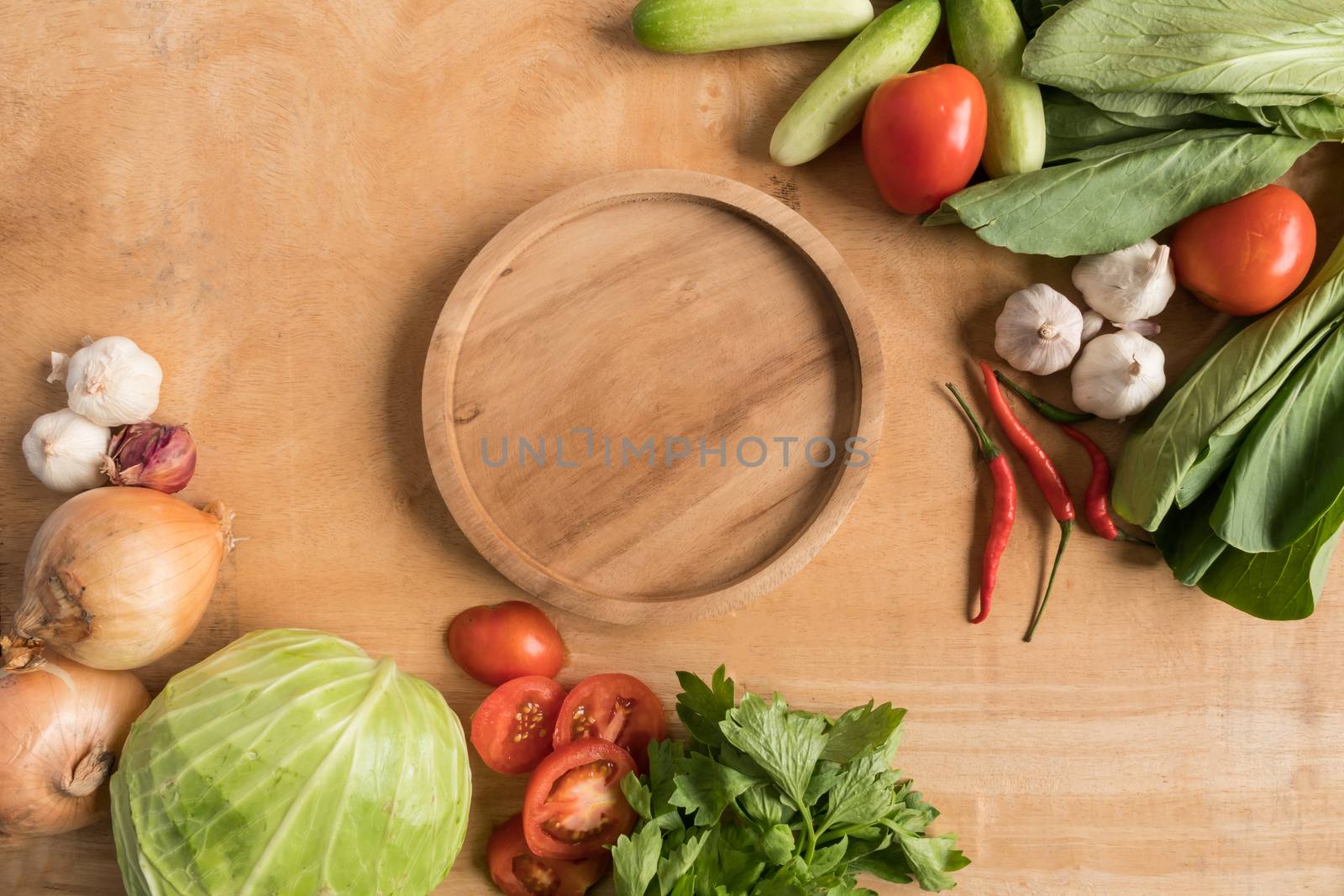 Top view of Fresh vegetables with wooden tray  on wooden table background.