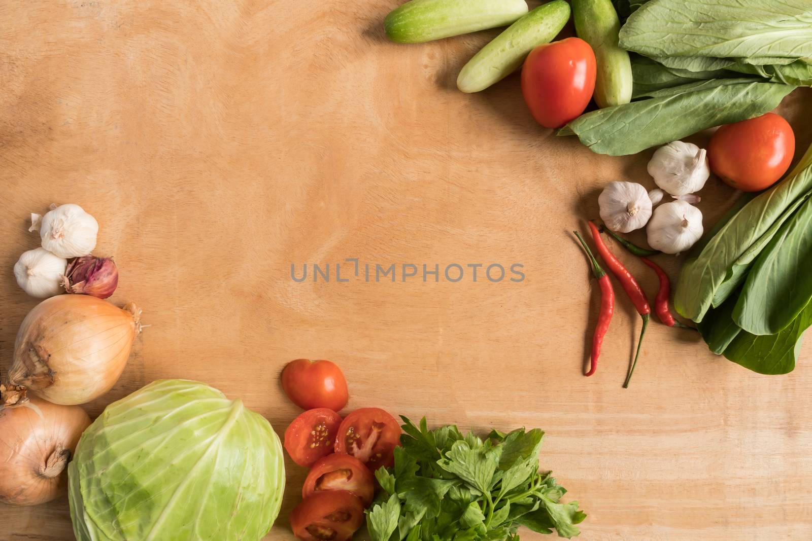 Top view of Fresh vegetables  on wooden table background.