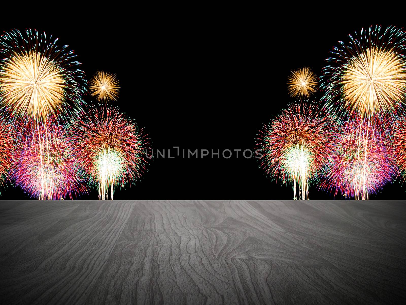 Empty wooden table in front of fireworks background.