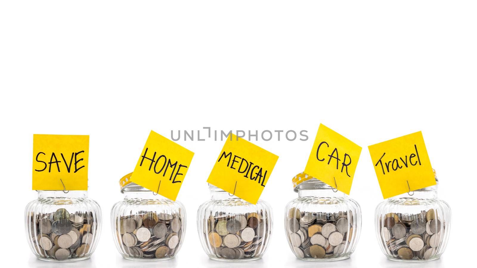 Coins in many glass bottles on white background, saving money concept