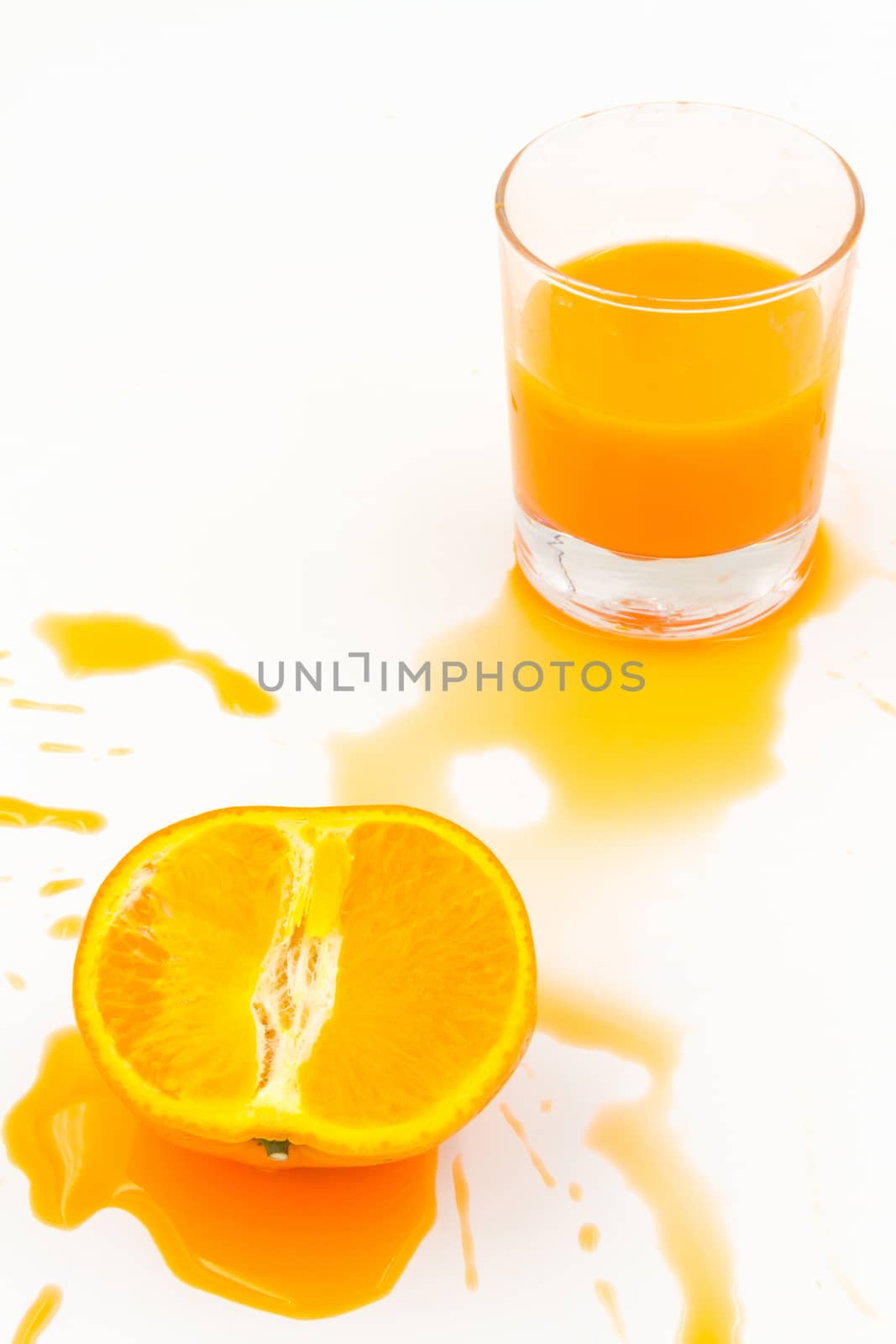 Orange juice and slices of orange on white background