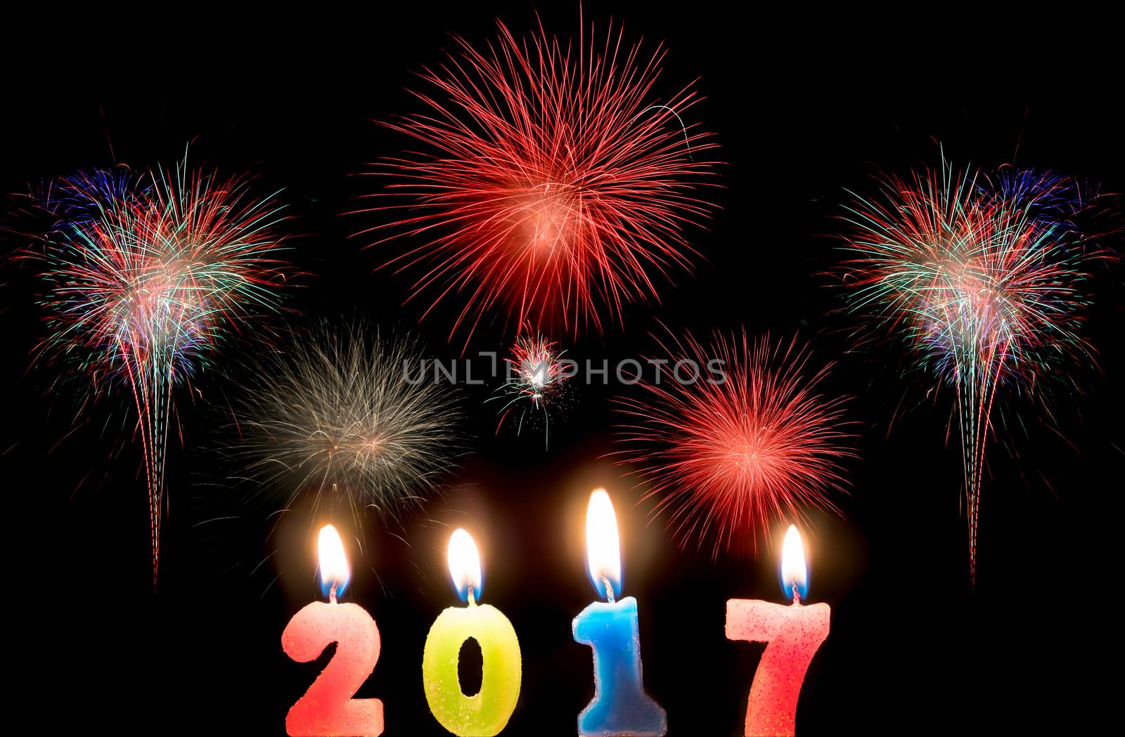 2017 candles numbers on fireworks background. New Year Concept