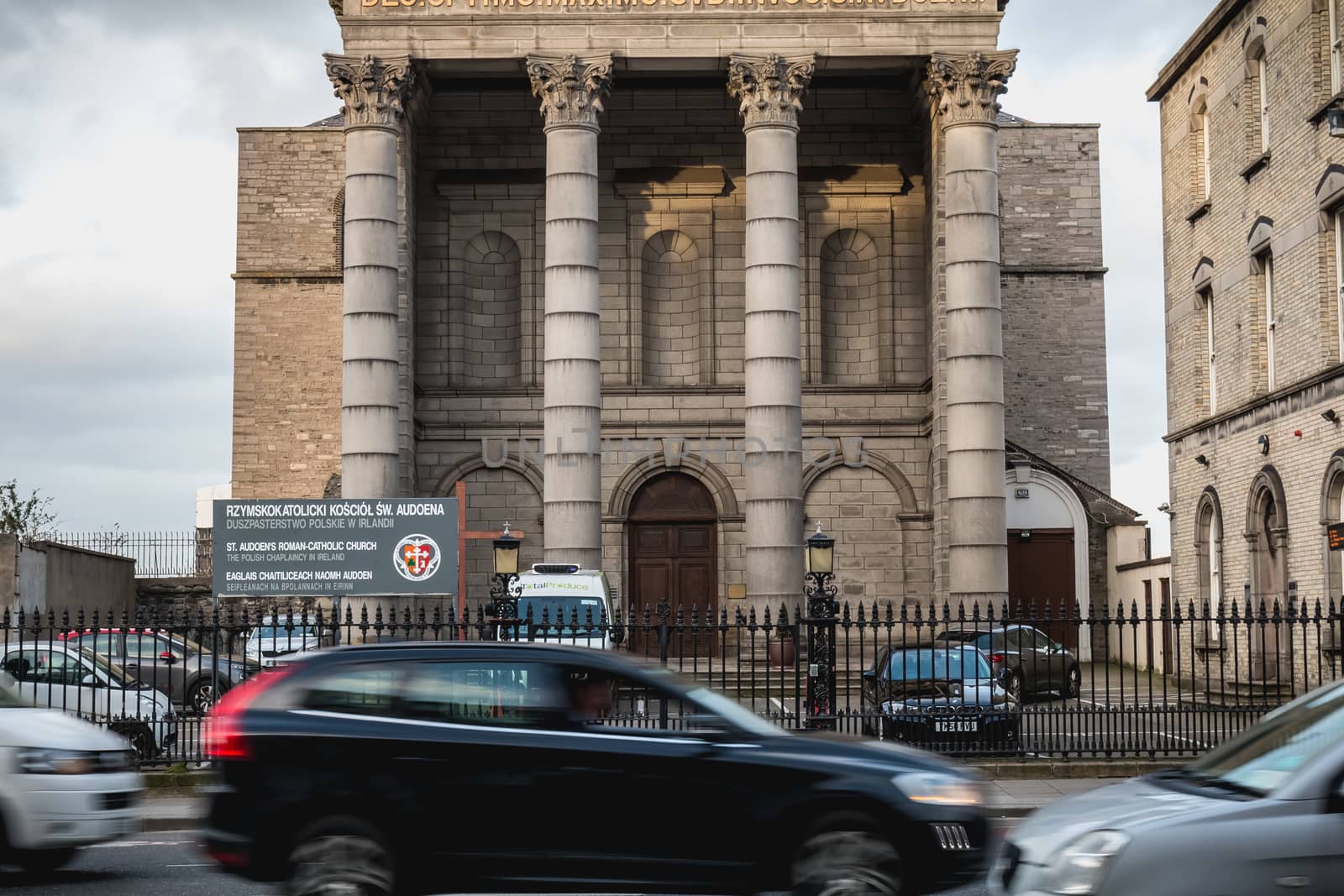 Dublin, Ireland - February 13, 2019: Street atmosphere and architecture of St. Audoen's Roman Catholic Church that people visit on a winter day