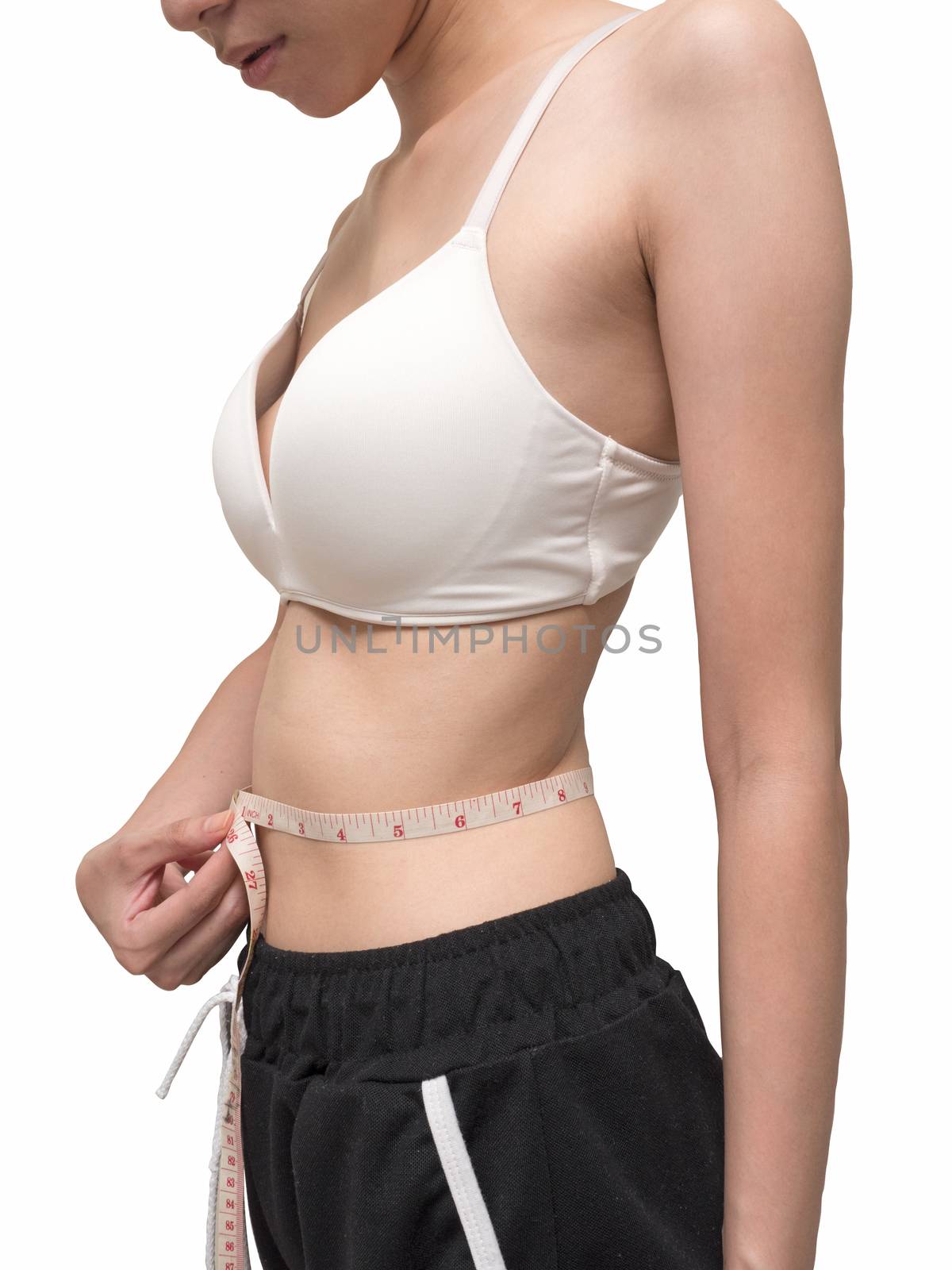 Close up of female body measuring her waist on white background, diet and healthy lifestyle by ronnarong