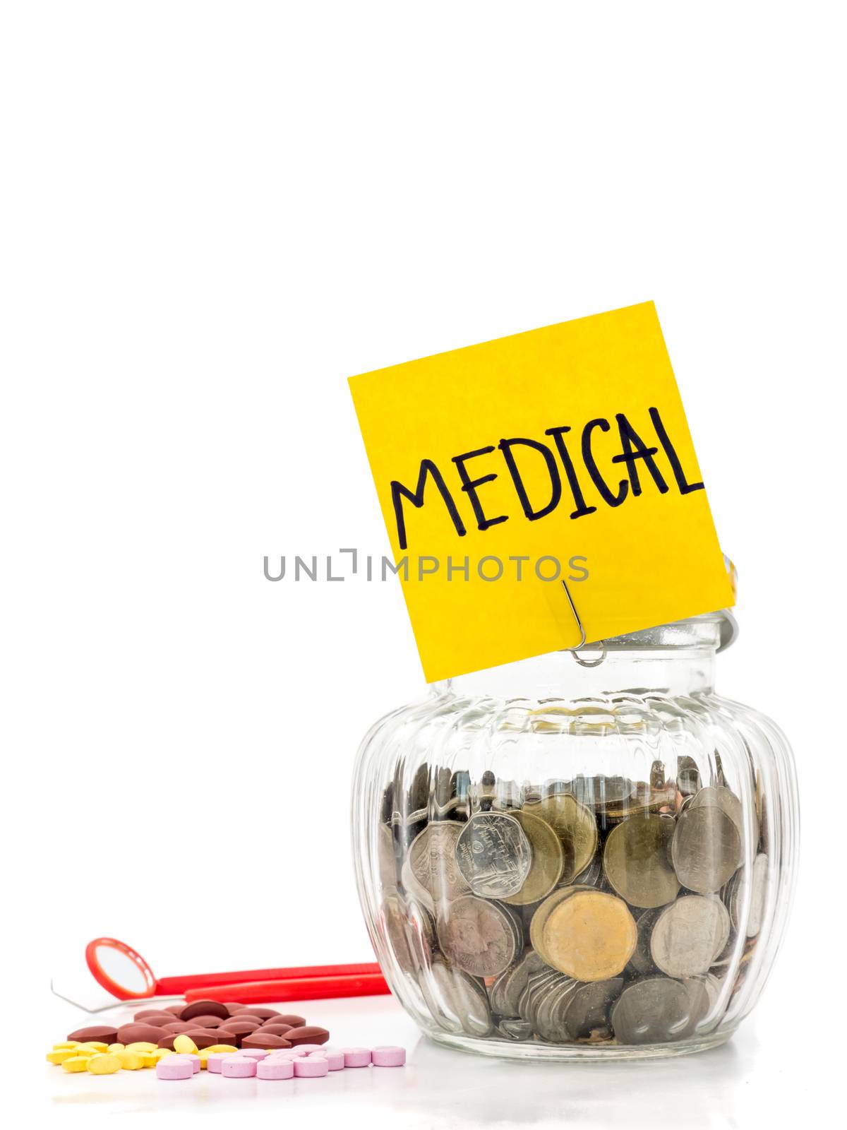 Coins in glass bottle with medicine on white background, saving money for Medical