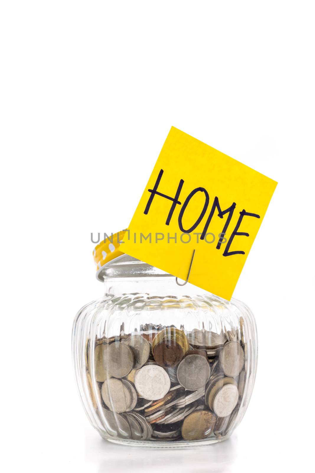 Coins in glass bottle on white background, saving money for Home