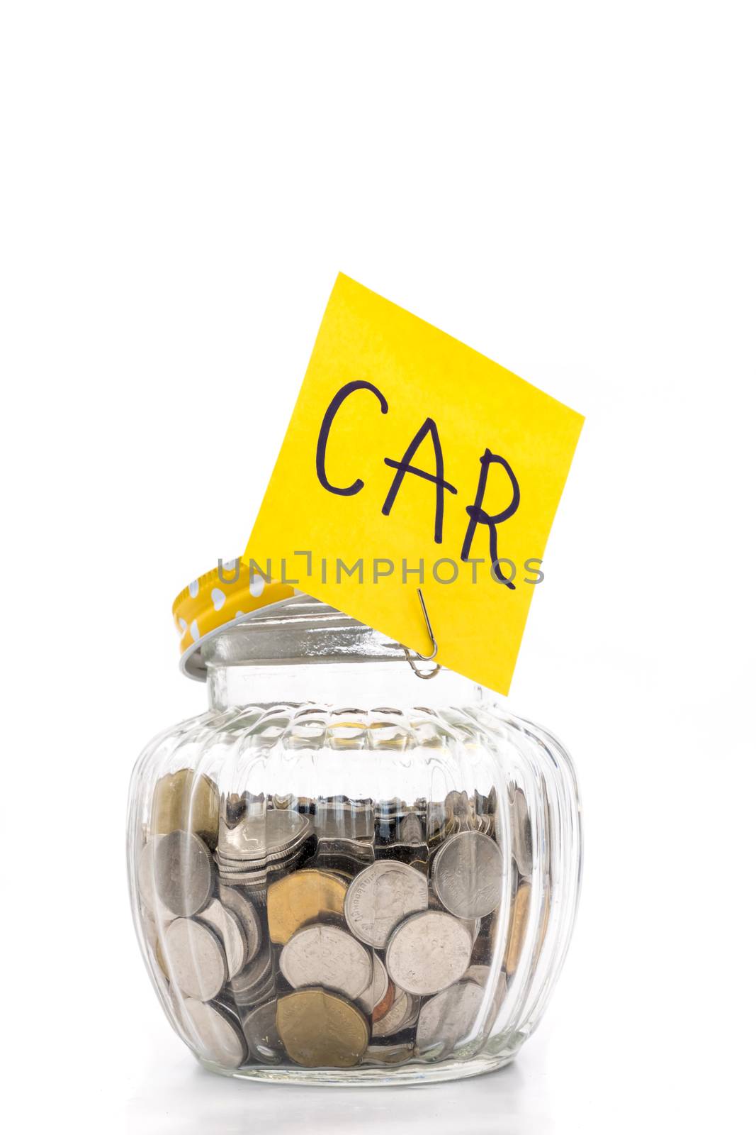 Coins in glass bottle on white background, saving money for Car