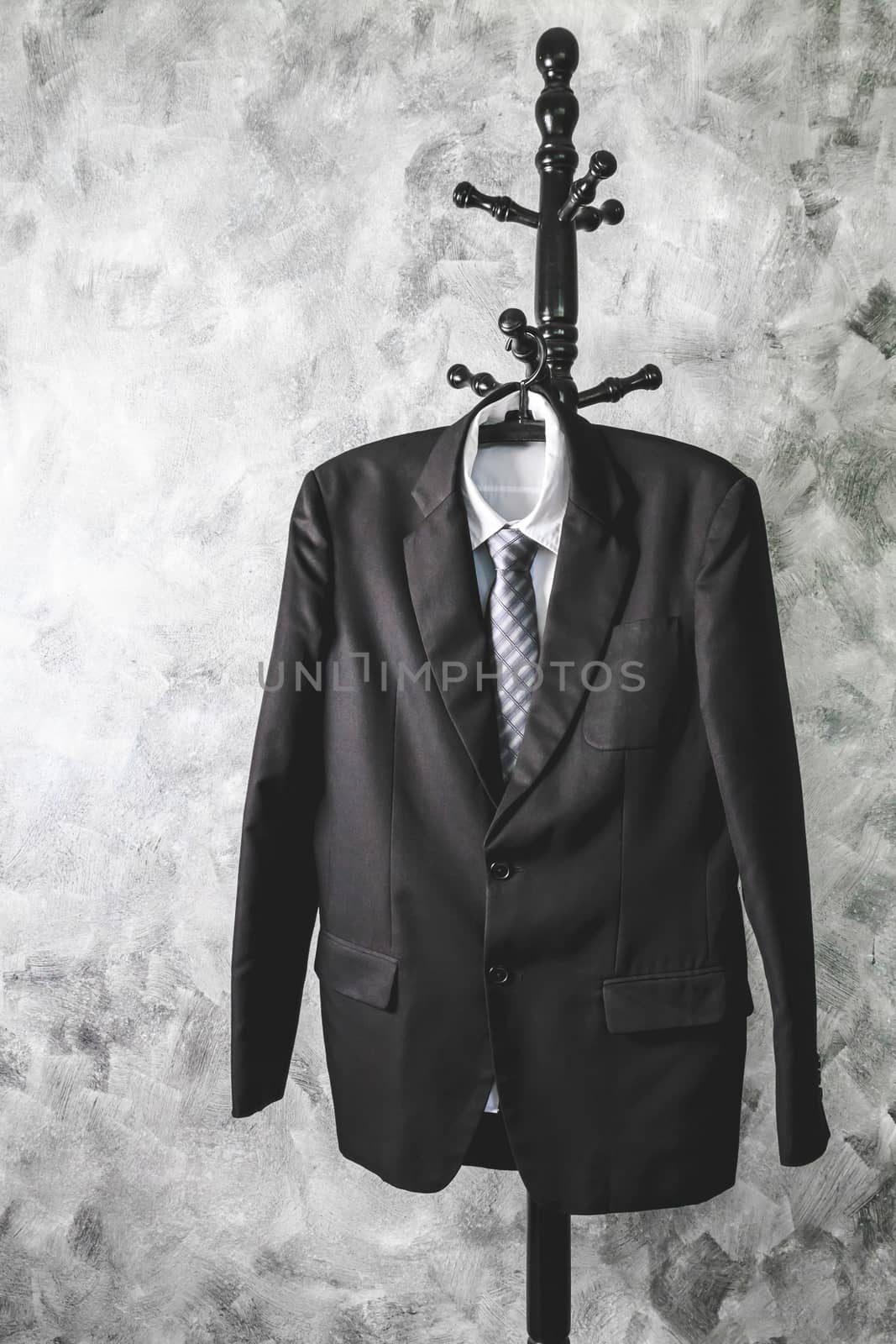 Black suit and tie and white shirt on grunge background.