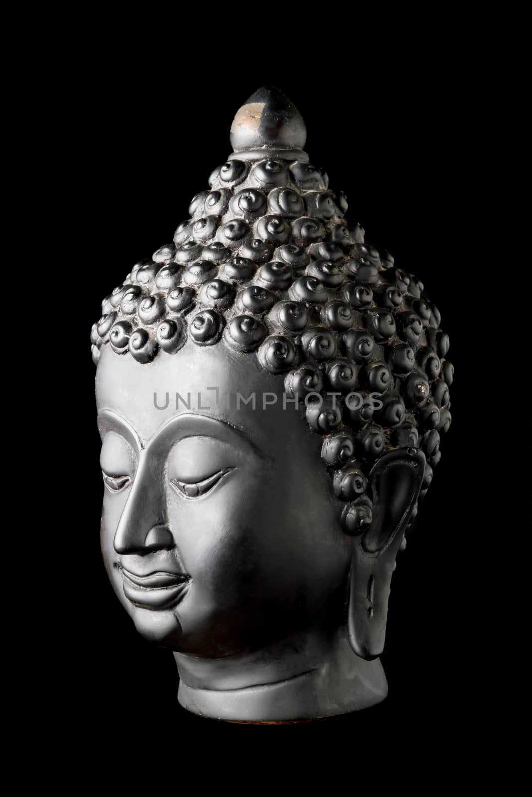 Buddha statue on black background.