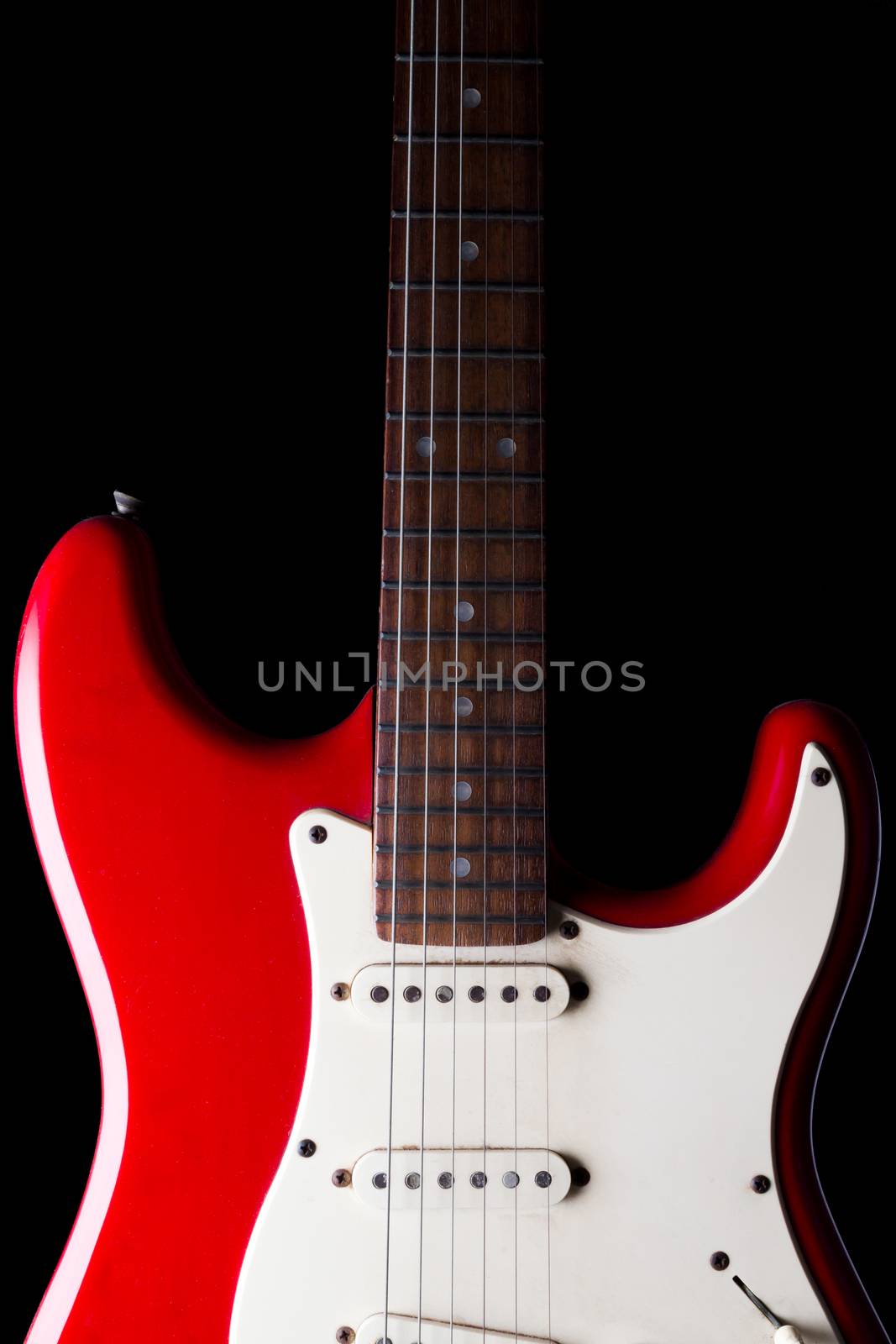 Close up of Electric guitar on black background. by ronnarong