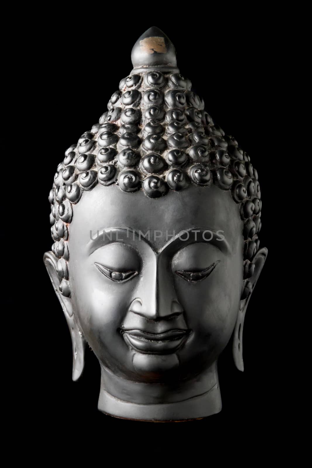 Buddha statue on black background.