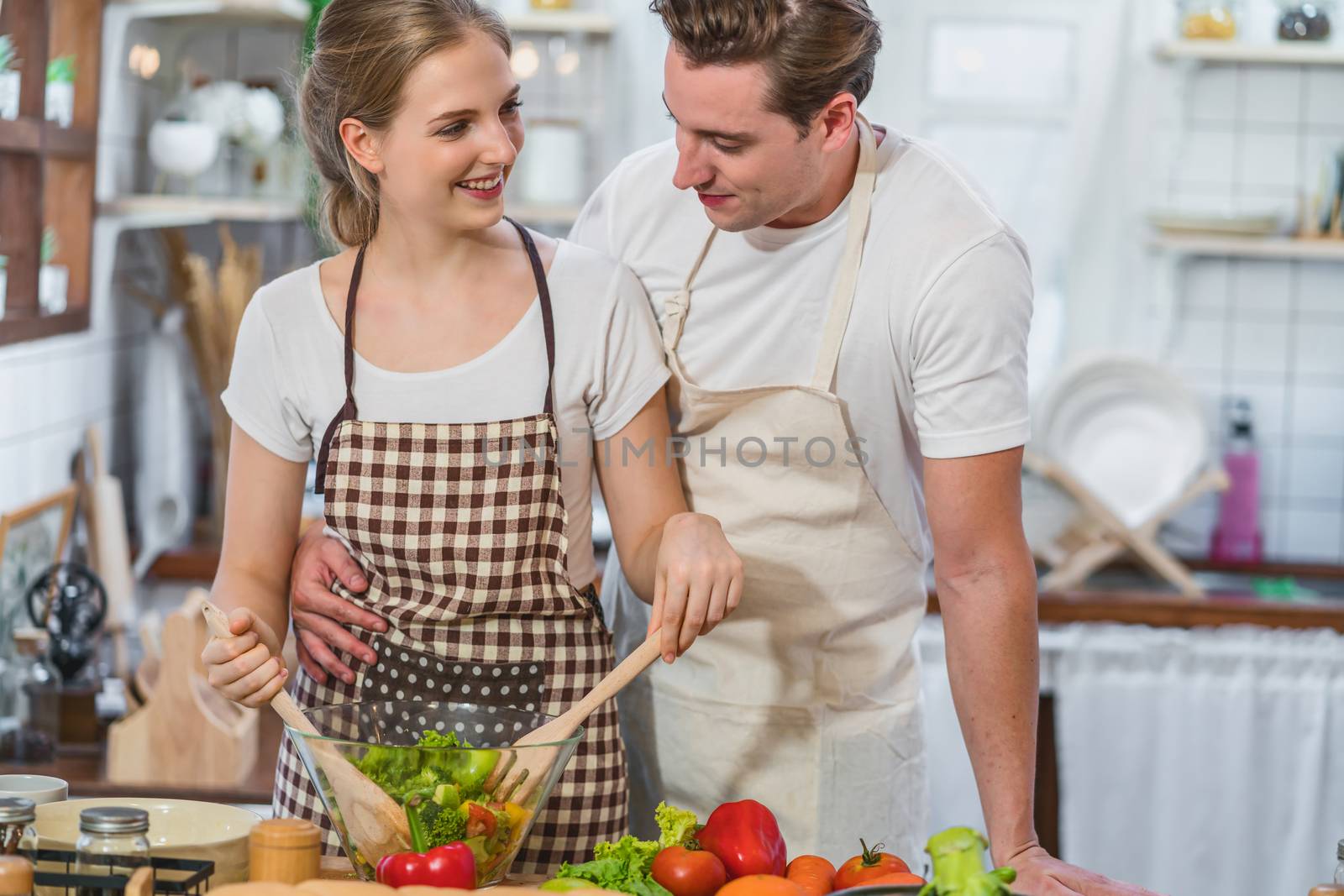 Caucasian couple or lovers cooking the breakfast with vegetables salad together in kitchen,just married and sweet honeymoon,relationship and healthcare,video social network,vlog and Influencer concept