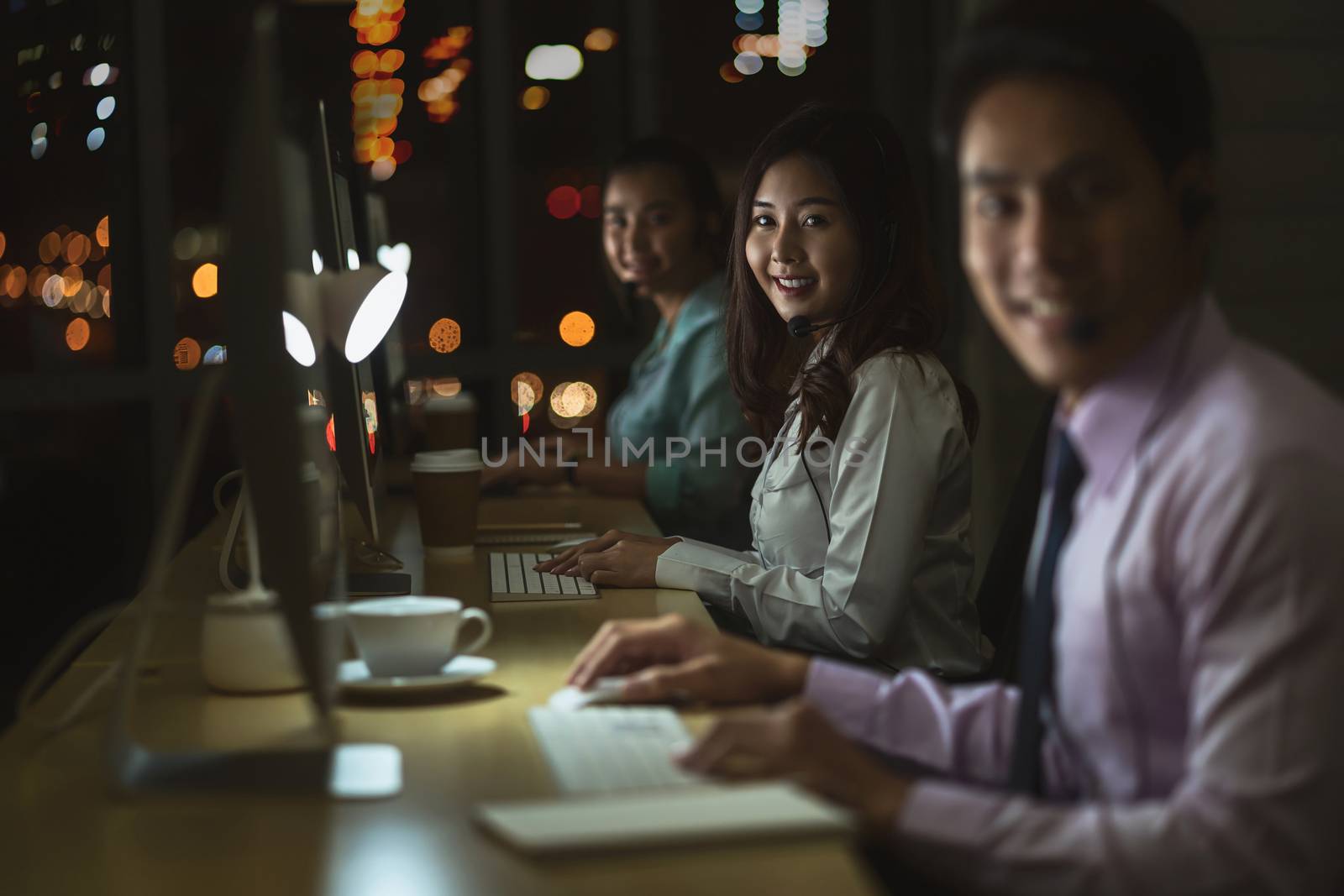 Portrait of Asian Male customer care service with businesswoman by Tzido