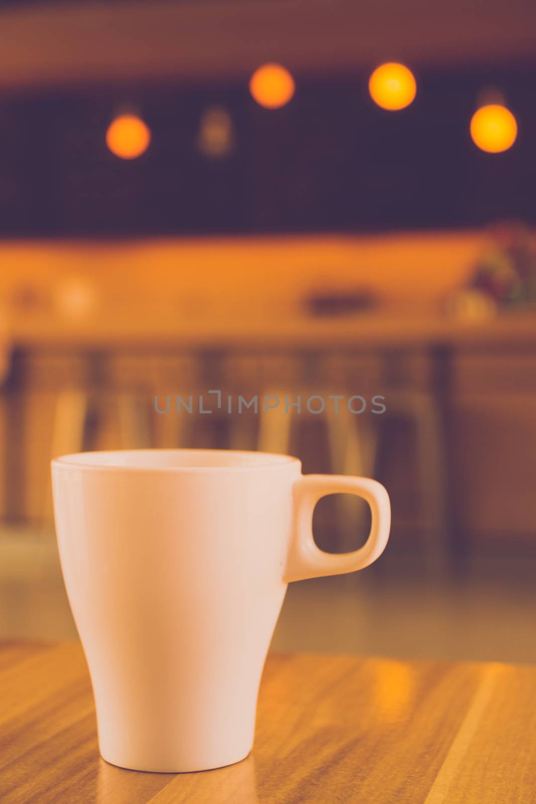 Cup of coffee on the table in cafe. Vintage tone by ronnarong