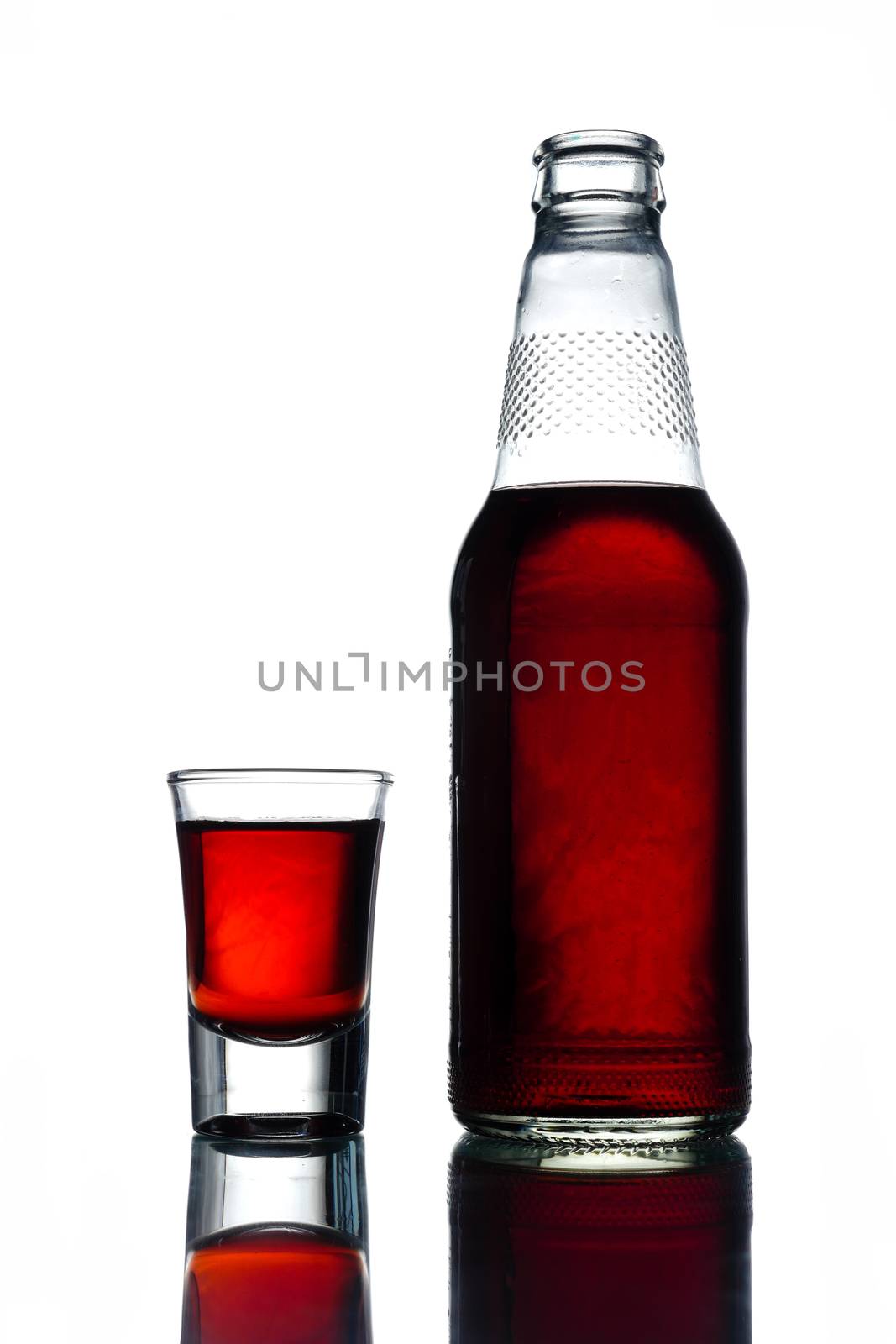 Bottle of alcohol with shot on a white background.