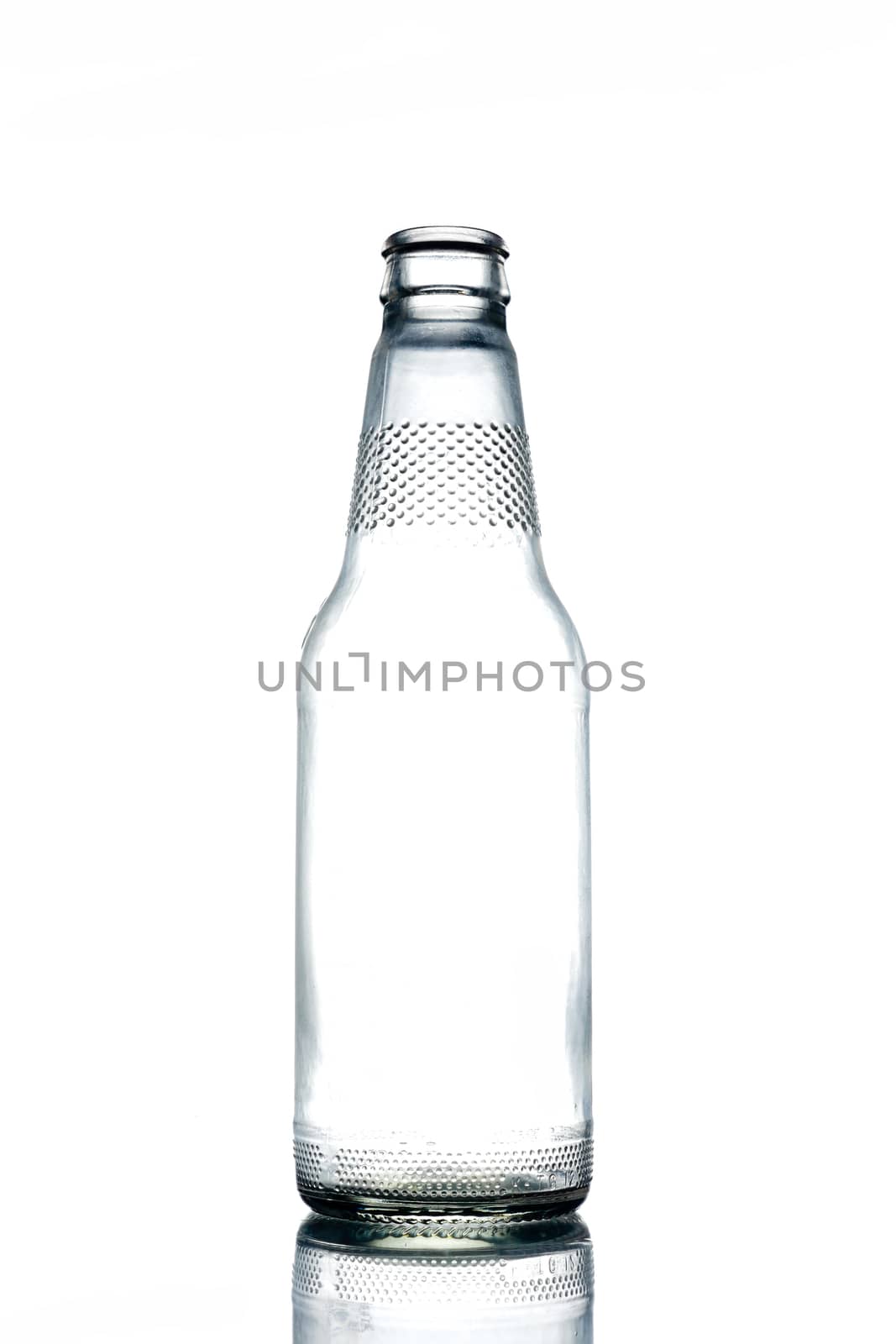Empty colorless glass bottle on a white background. by ronnarong