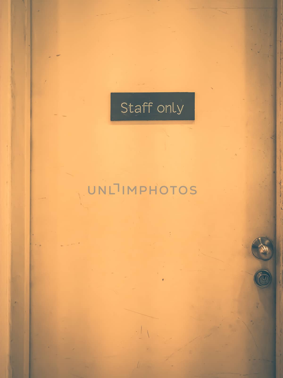 Staff only sign on a old door. Vintage tone