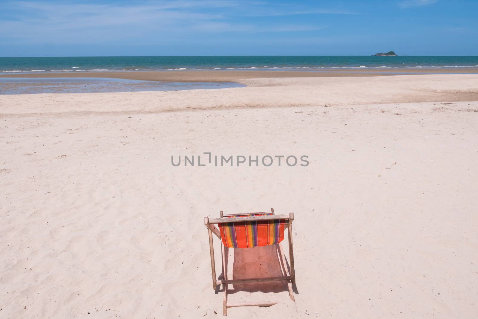 Red canvas chair on the beach.