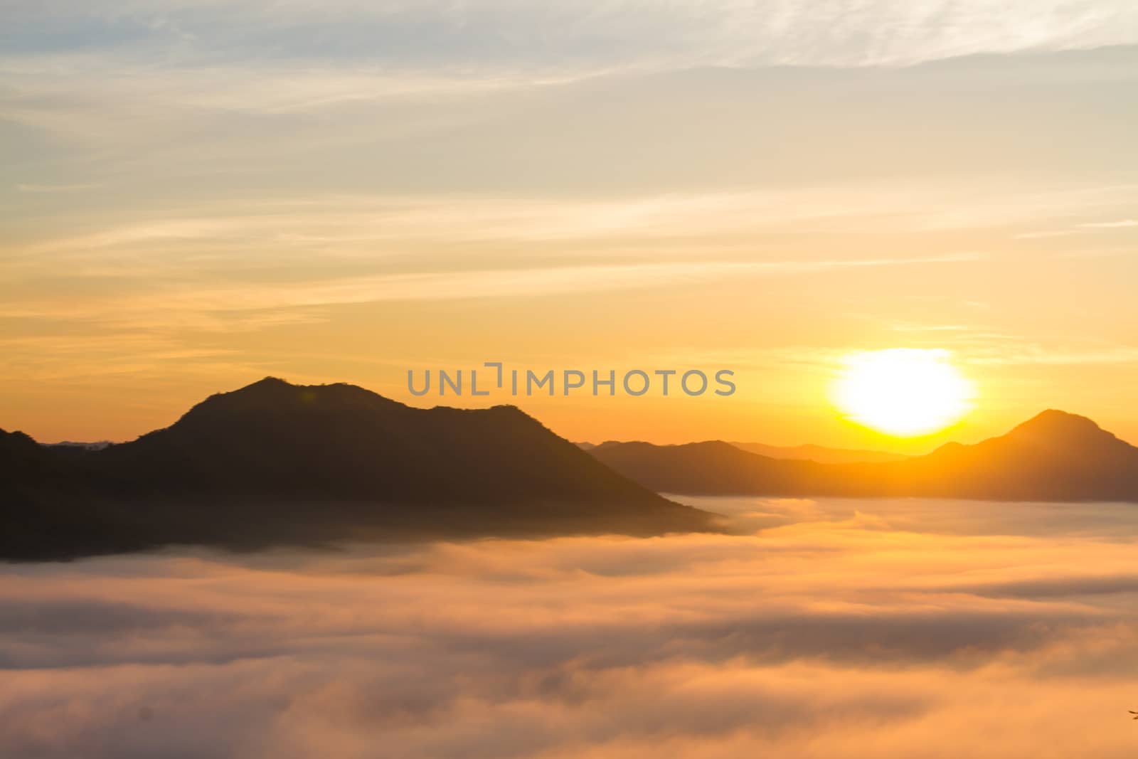 Beautiful landscape with mountains, mist and sun in the morning. Travel background.