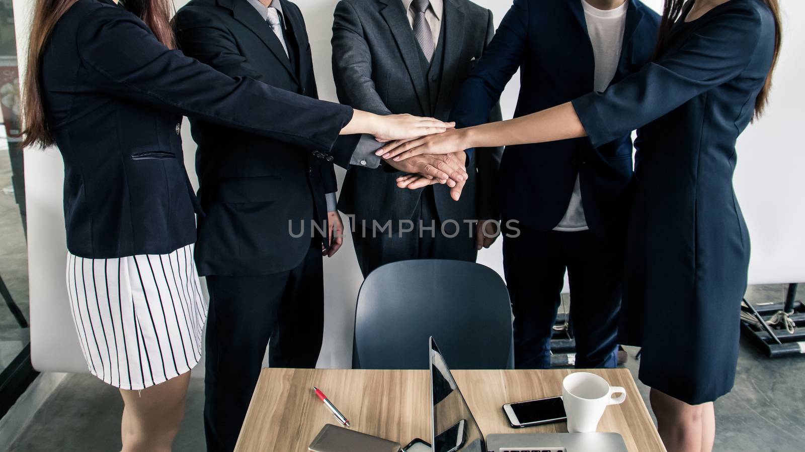 Business people joining hands together, success and teamwork concept.