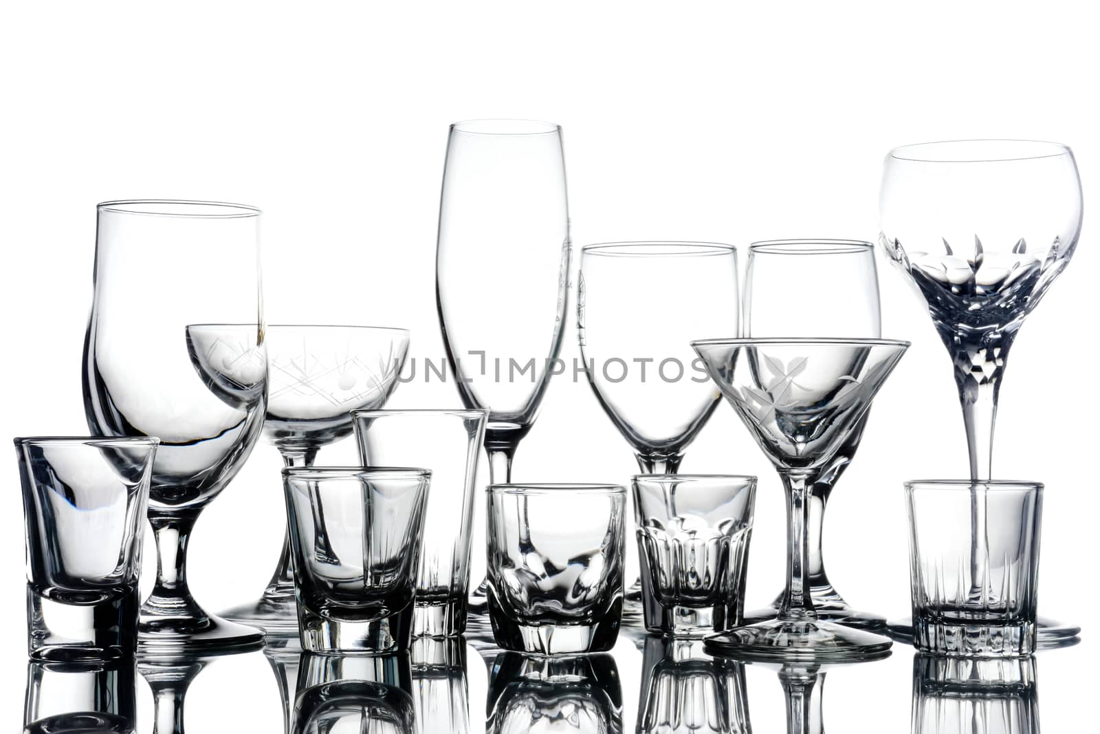 Collage of empty glasses on white background.