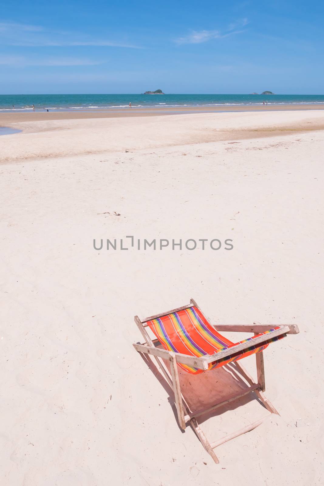Red canvas chair on the beach.