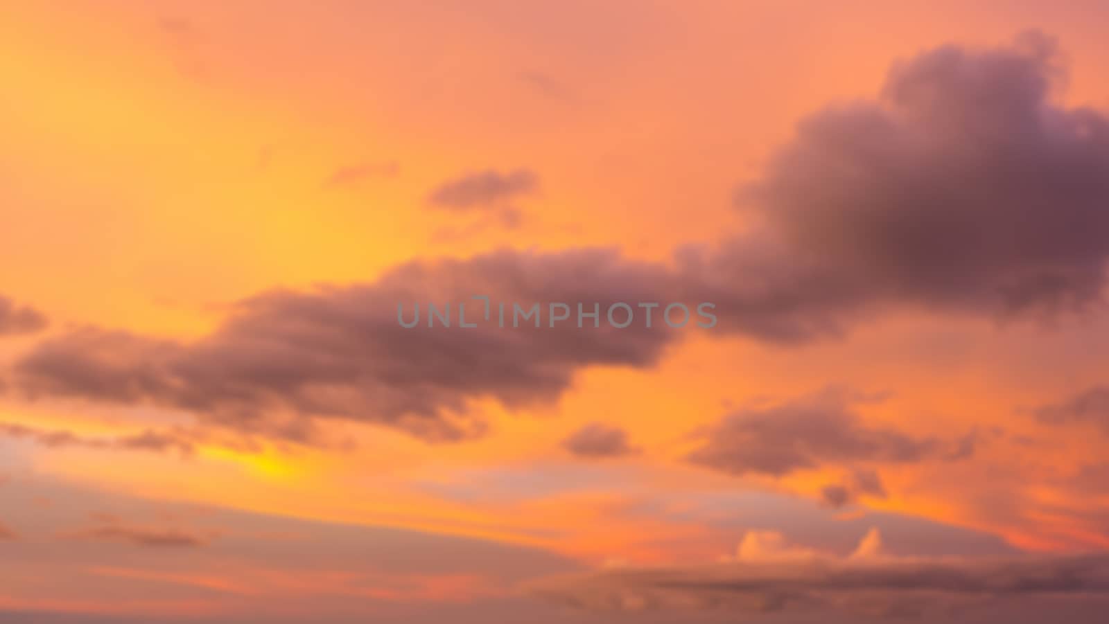 Dramatic sunset sky with clouds. Blur or defocus image.