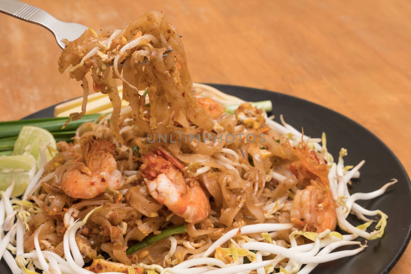 Close up plate of Padthai, Thai noodle with fried shrimp and vegetable,Thai Food, Thailand's national dishes.