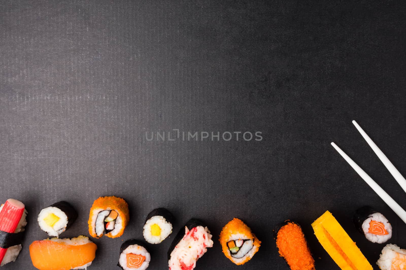 Top view of Sushi set and chopsticks on black background, Japanese food. Free space for text