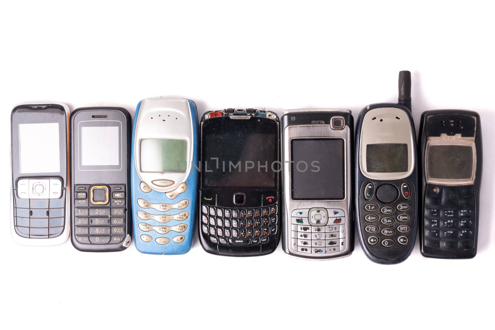 old and obsolete cellphone on a white background.