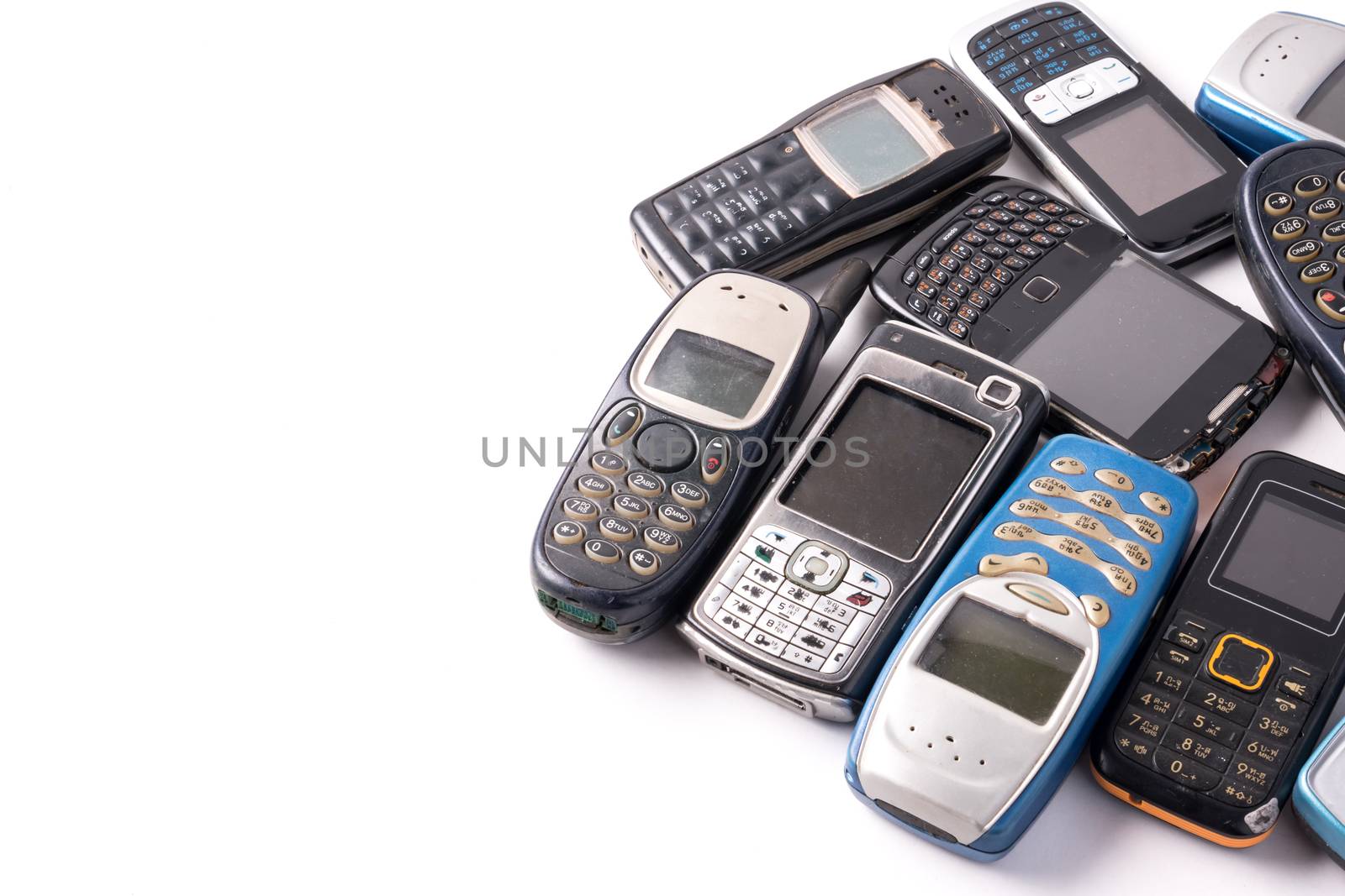 old and obsolete cellphone on a white background. Free space for text