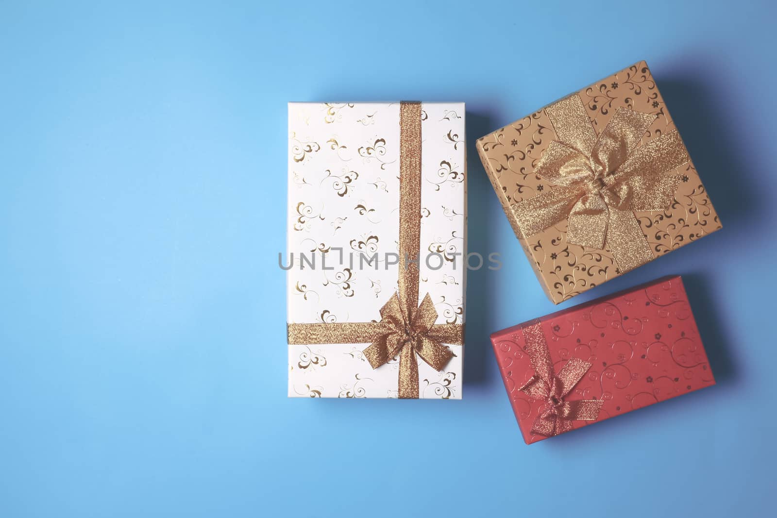 Top view of gift boxes on blue background. Free space for text