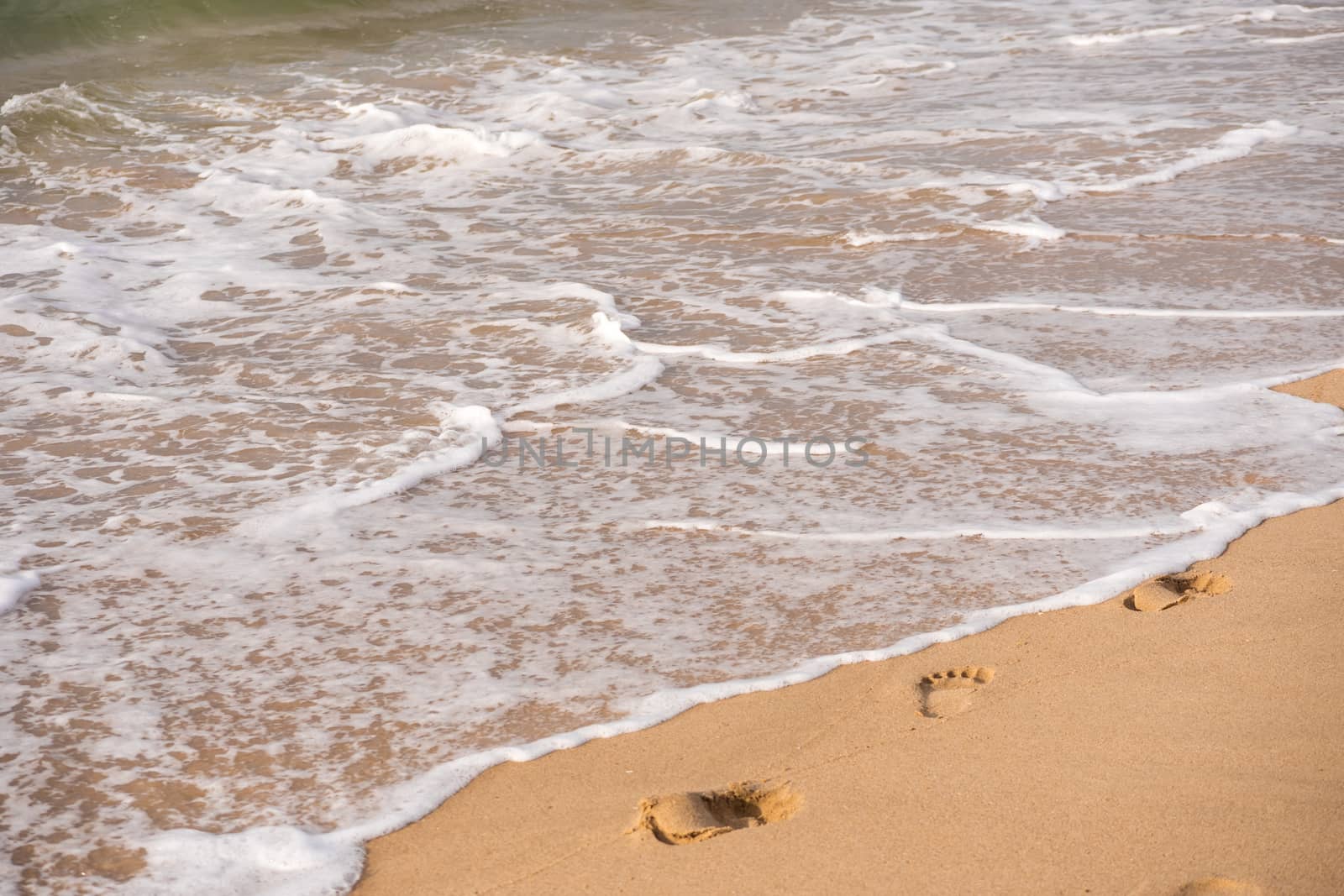 Footprints on a sandy beach. Travel concept