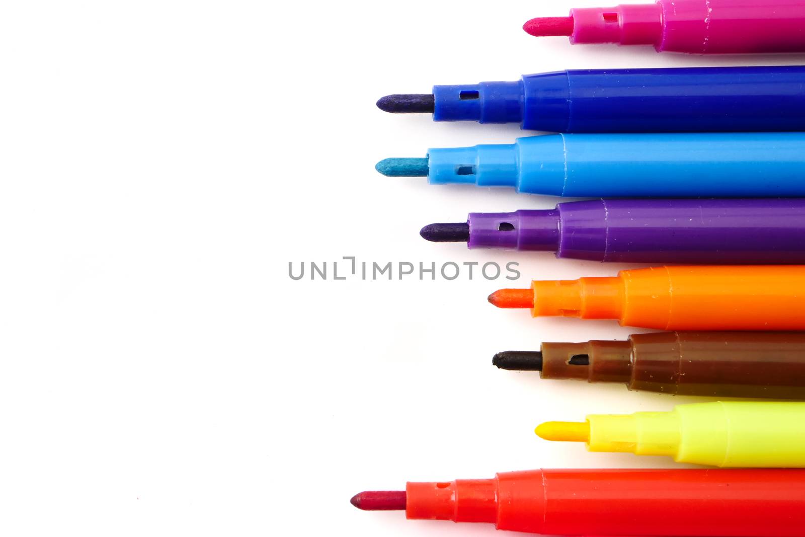 Magic colorful pens on a white background. Free space for text