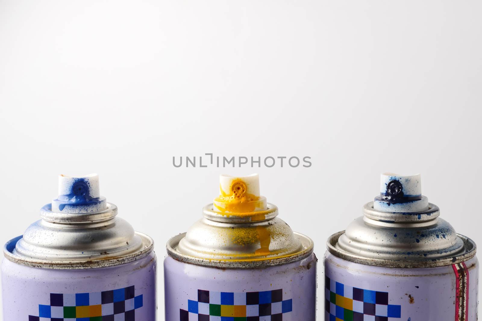 Used cans of spray paint on a white background, Close up, Free space for text.