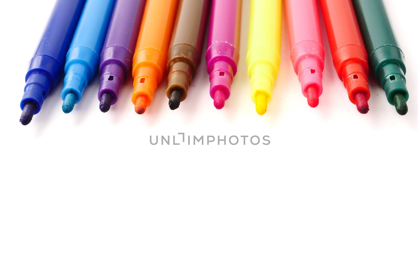 Magic colorful pens on a white background. Free space for text