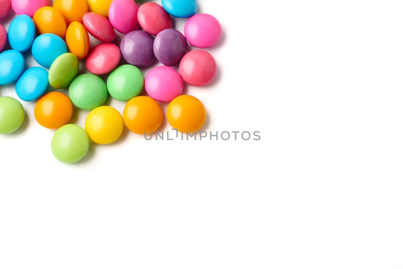 Colorful candies on a white background, Free space for text.