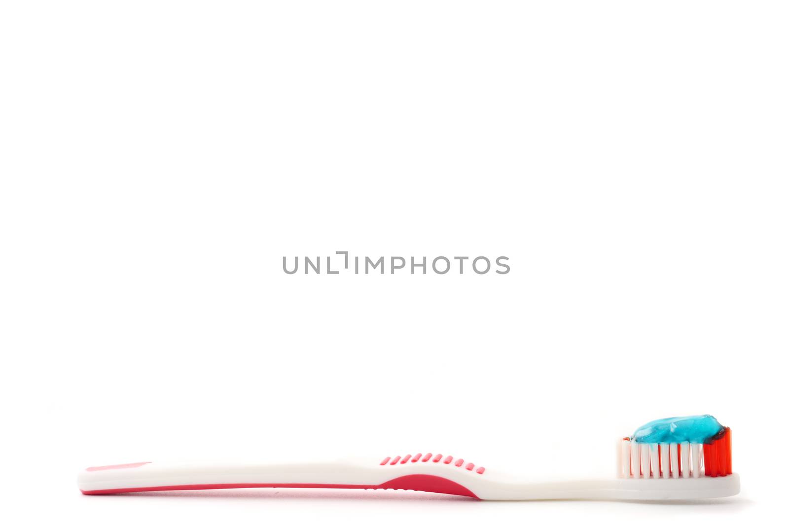 Toothbrush with toothpaste on a white background. Free space for text by ronnarong