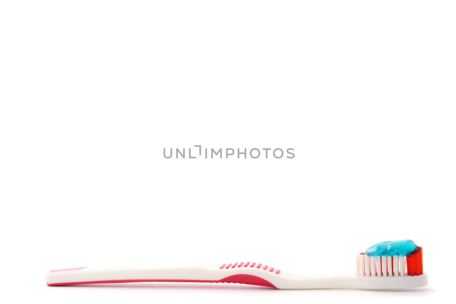 Toothbrush with toothpaste on a white background. Free space for text