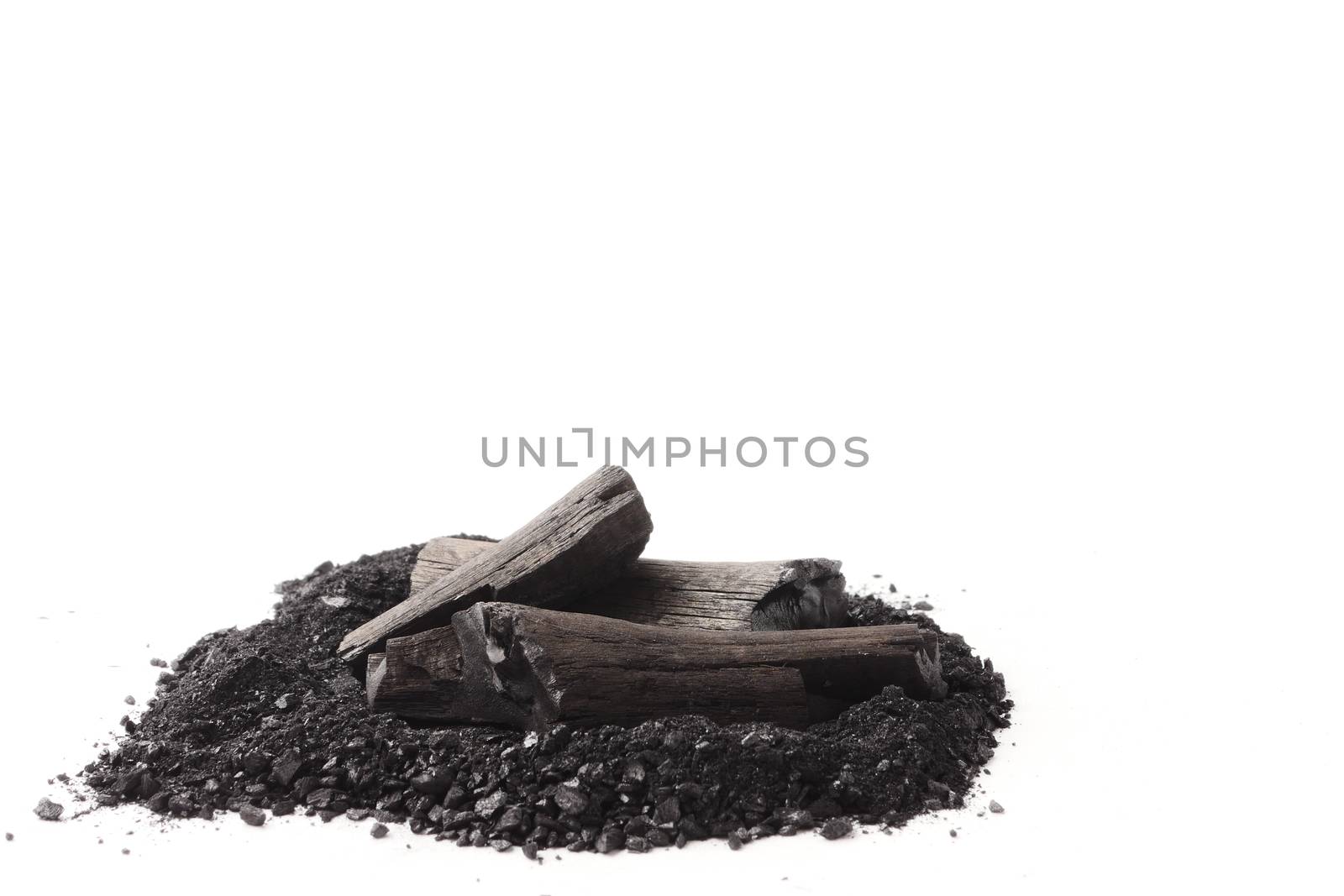Charcoal and powder (activated carbon) on white background. Free space for text