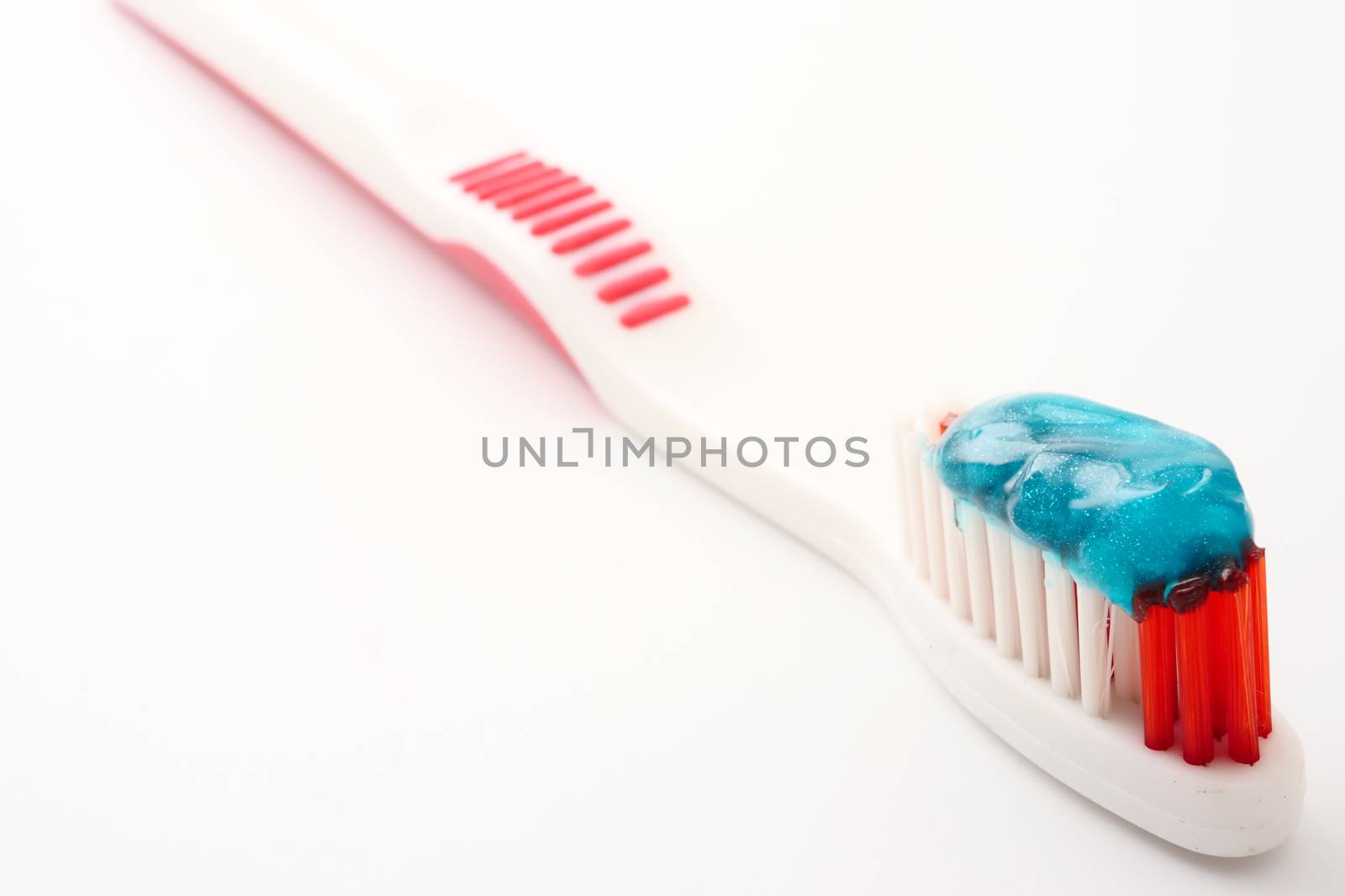 Close up of Toothbrush with toothpaste on a white background.