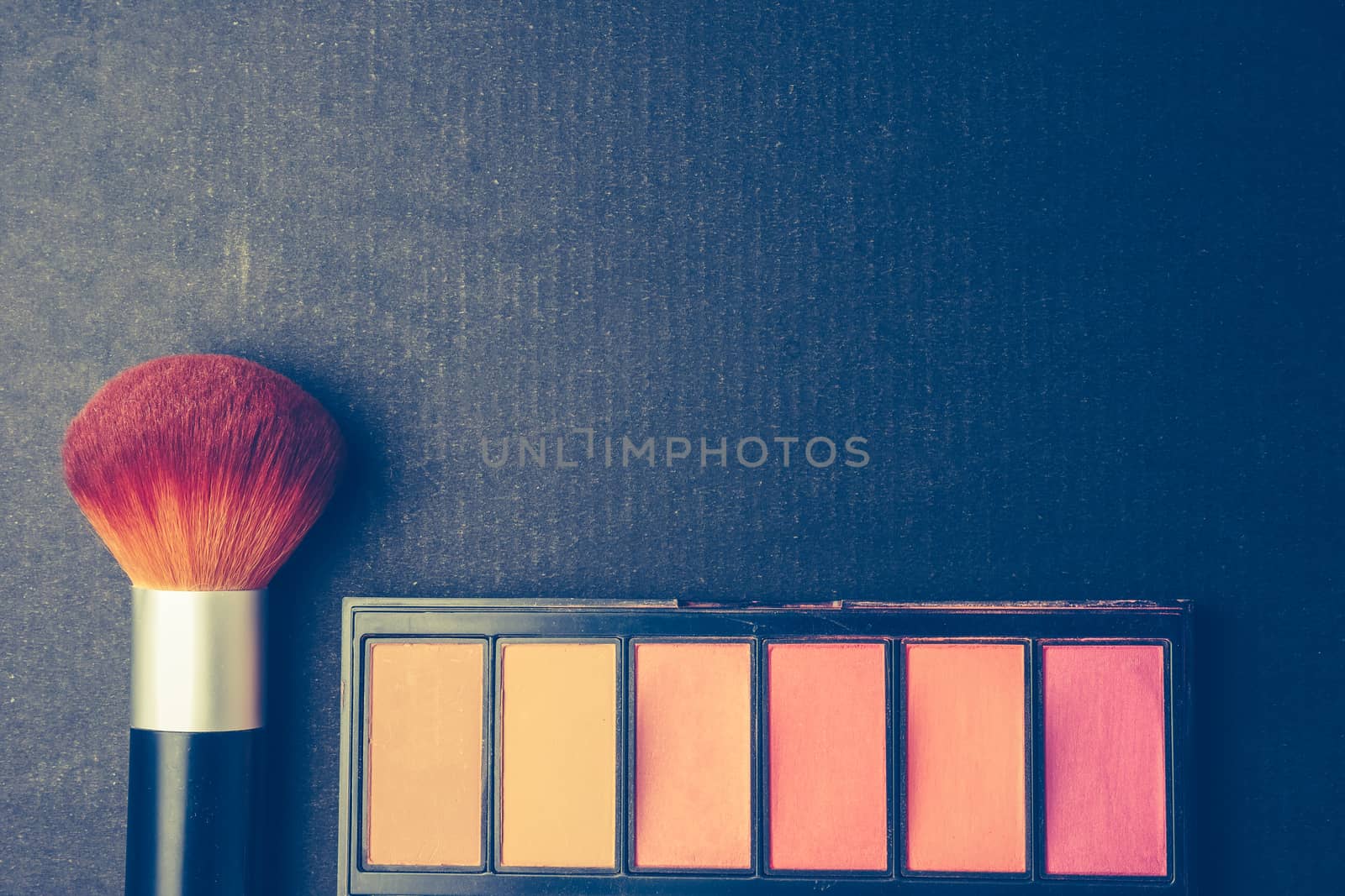 Makeup brush and palette on black background, Vintage tone, Free space for text.