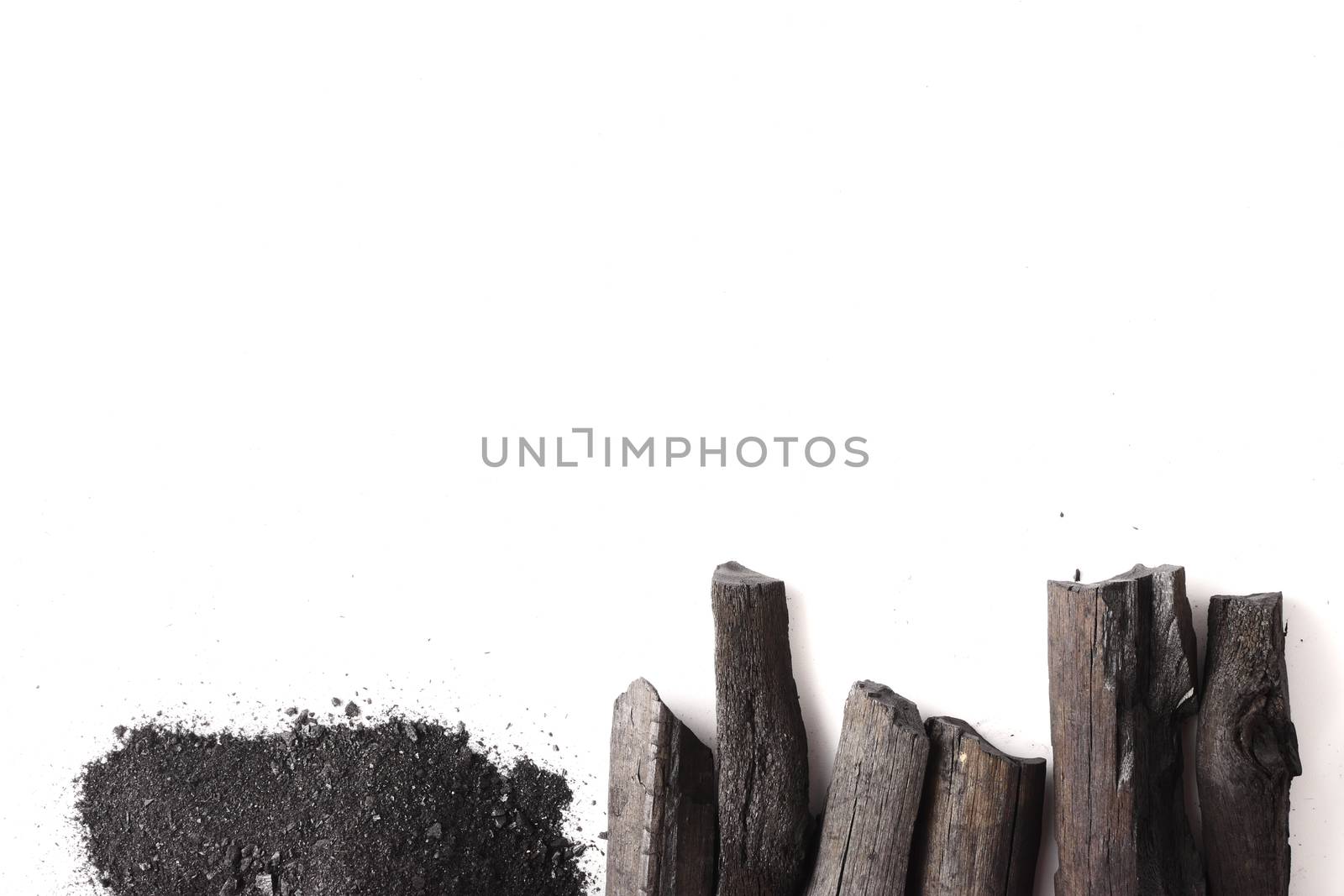 Charcoal and powder (activated carbon) on white background. Free space for text