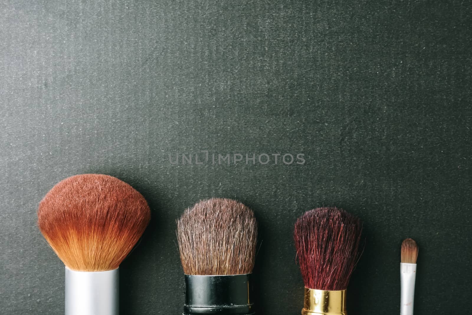 Makeup brushes on black background, Free space for text.