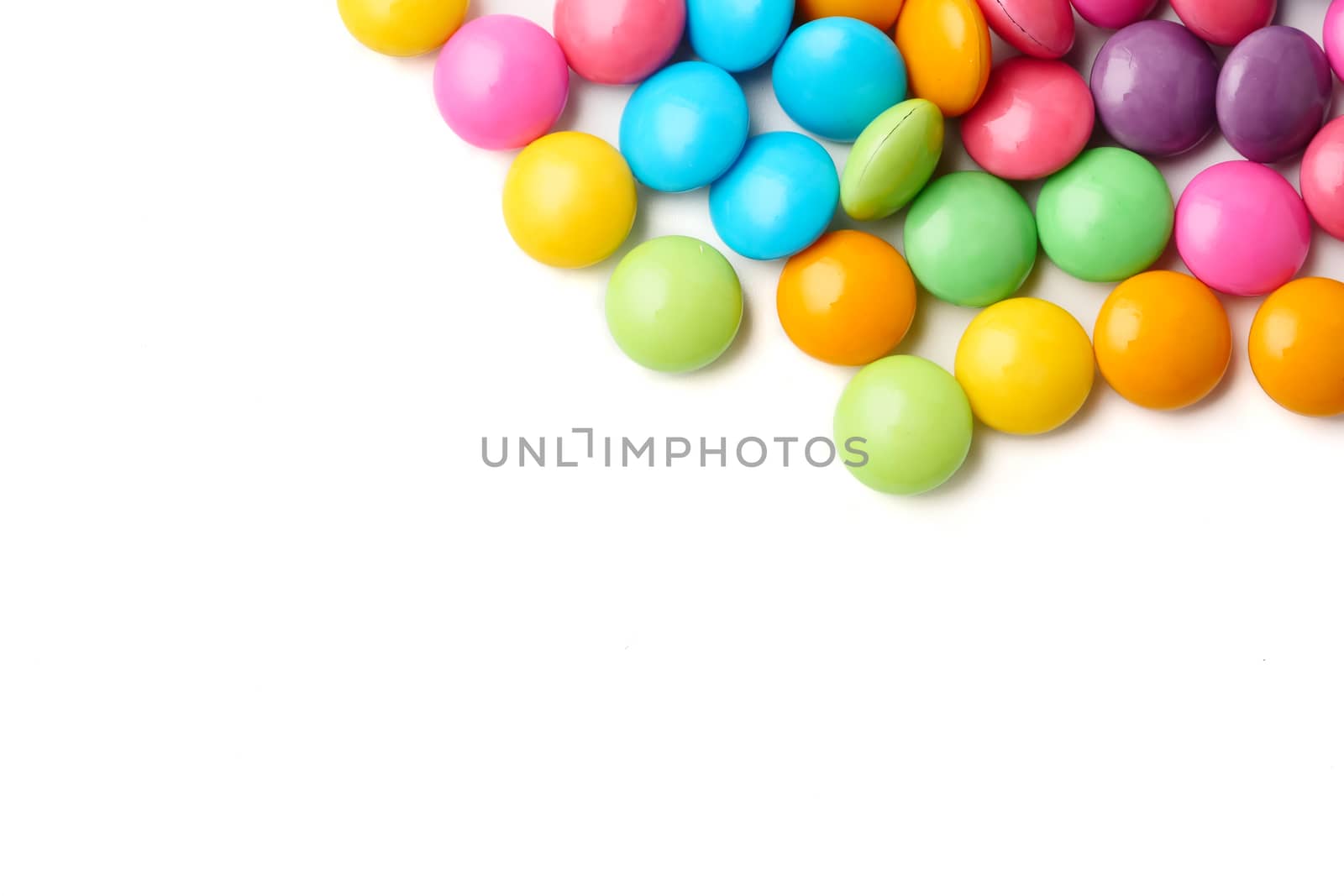 Colorful candies on a white background, Free space for text.