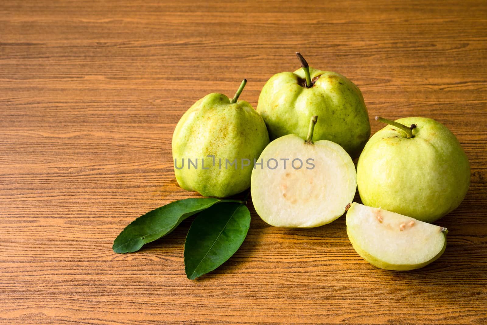 Fresh guava fruit on wooden table background.